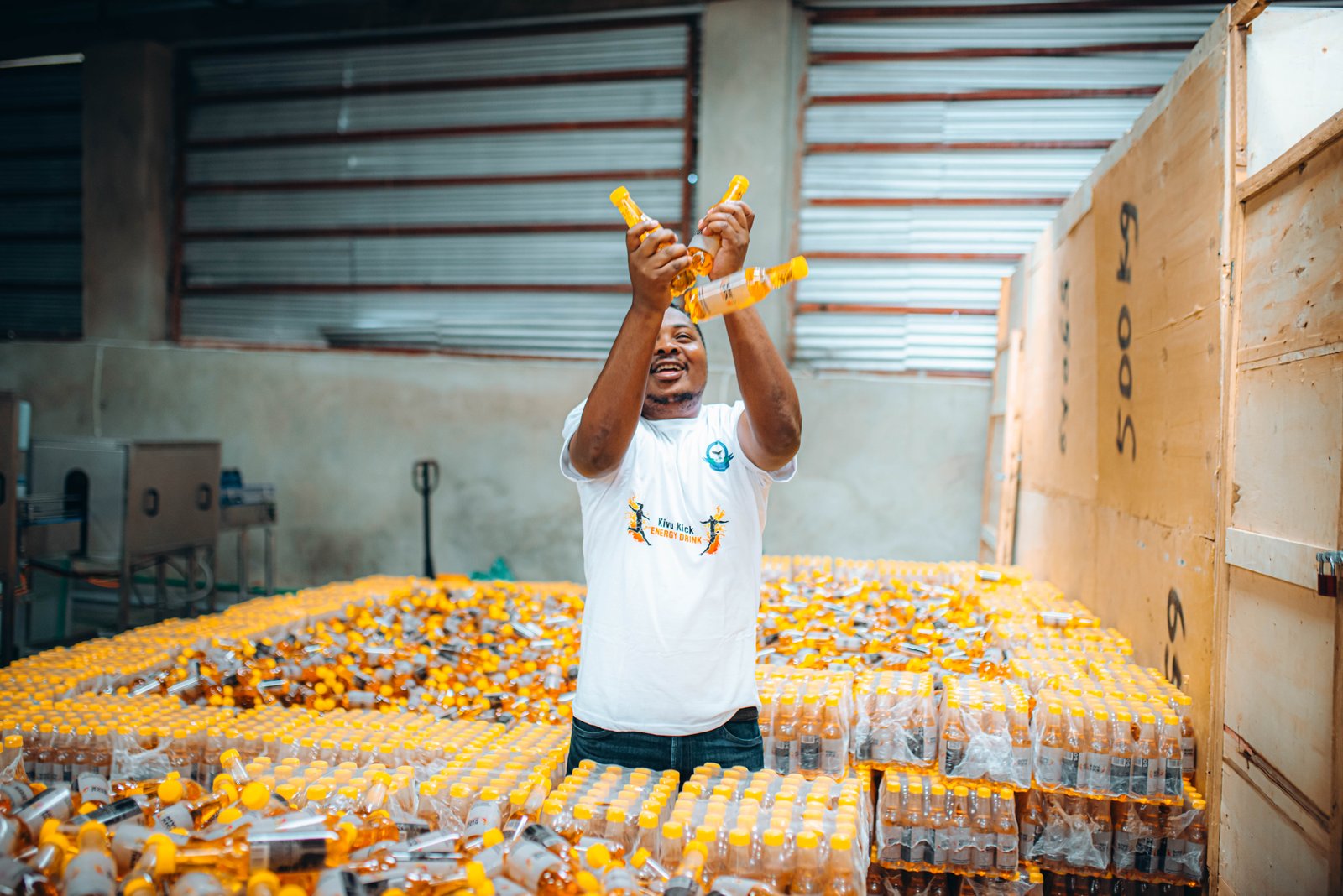 KSC team member celebrating with Kivu Kick bottles